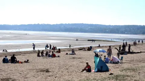 PA Sunbathers in Swansea Bay