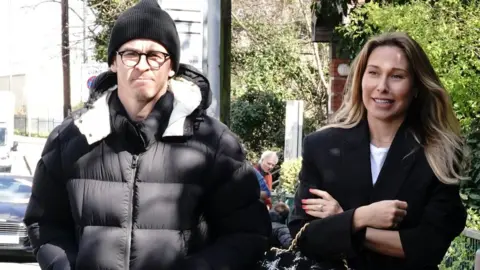 PA Media Joey Barton leaving Wimbledon Magistrates" Court with his wife Georgia