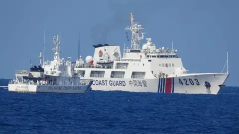 Reuters Philippine Coast Guard ship (left) and Chinese Coast Guard ship. Photo: June 2023