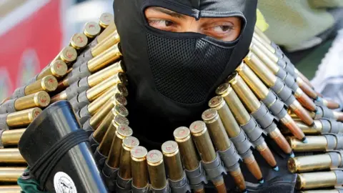 Reuters An armed man attends a funeral of Palestinians killed by Israeli forces in Jenin (28/09/22)