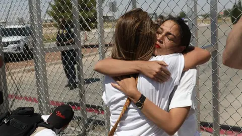 Getty Images Alexandria Ocasio-Cortez is embraced at the Tornillo-Guadalupe port of entry gate on June 24, 2018 in Tornillo, Texas.