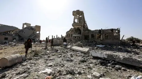 Getty Images Rubble of a building hit by an air strike of the Saudi-led coalition, in Sanaa on 1 September 2019