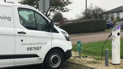 MU Van parked at electric vehicle charging point