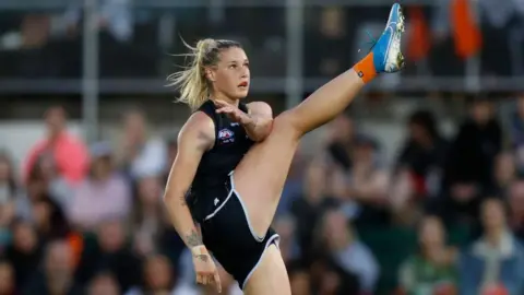 Getty Images Tayla Harris kicking a ball