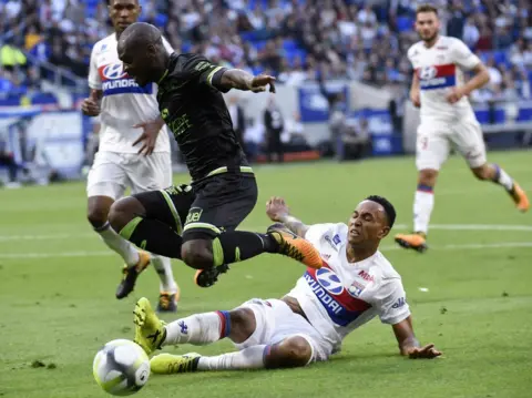 AFP Guingamp"s French-Congolese defender Jordan Ikoko (L) vies with Lyon"s Dutch defender Kenny Tete (bottom) during the French L1 football match Lyon (OL) vs Guingamp (EAG), on September 10, 2017 at the Groupama stadium in DÃ©cines-Charpieu near Lyon, southeastern France.
