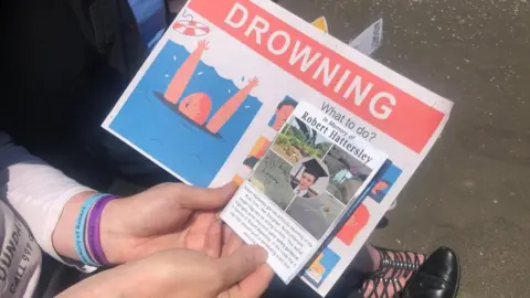 Robert Hattersley's father holding drowning awareness leaflet