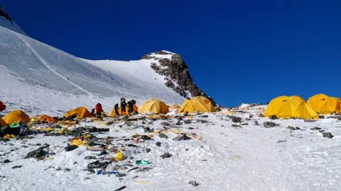 Dom Sherpa/AFP This picture taken on May 21, 2018 shows discarded climbing equipment and rubbish scattered around Camp 4 of Mount Everest.