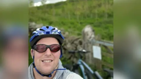 Gareth Cowin takes a selfie in front of field proposed for track