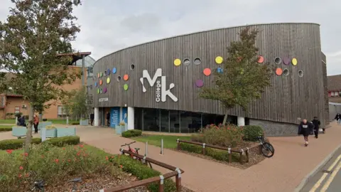 Google Milton Keynes College - a timber-clad building with trees in the foreground