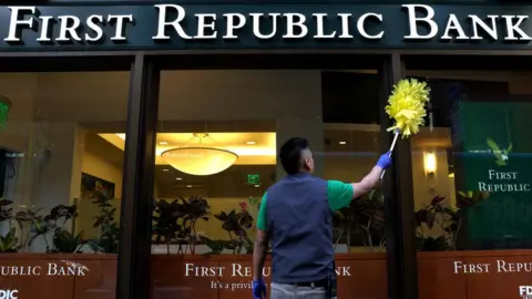 Getty Images A worker cleans the exterior of a First Republic Bank branch in San Francisco, California.