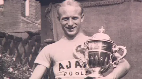 Percy Stallard holding a trophy