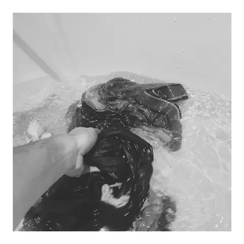 Richard Tymon Washing clothes in the bath