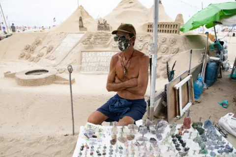 Francesca Gennari A street vendor selling figurines on the beach