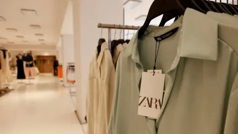 Reuters Zara clothes hanging in store