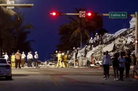 Reuters Emergency crews respond to a partially collapsed residential building in Surfside, near Miami Beach Florida, U.S. June 24, 2021.