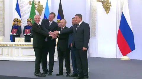 Kremlin handout A screen grab form Kremlin shows the heads of 4 Ukrainian separatist regions Vladimir Saldo, Yevgeny Balitsky, Denis Pushilin, Leonid Pasechnik and Russian President Vladimir Putin