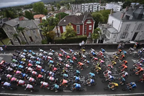 ANNE-CHRISTINE POUJOULAT/AFP An elevated view of a large number of cyclists taking part in the Tour de France