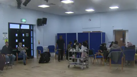 People affected by the security alert in Irish Street community centre