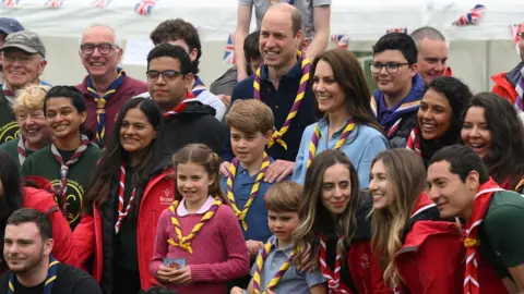 PA Media The Prince of Wales, Princess of Wales, Prince George, Princess Charlotte and Prince Louis pose with volunteers after helping to renovate and improve the 3rd Upton Scouts Hut in Slough, as part of the Big Help Out, to mark the crowning of King Charles III and Queen Camilla