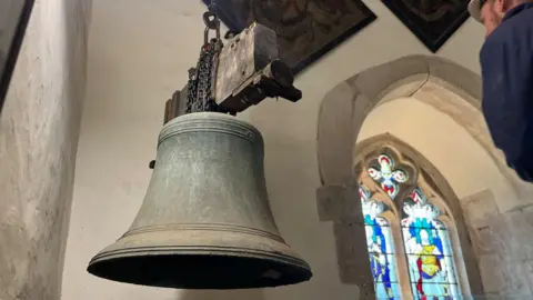 A bell being removed in the church