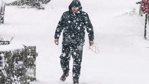 Man walks in snow