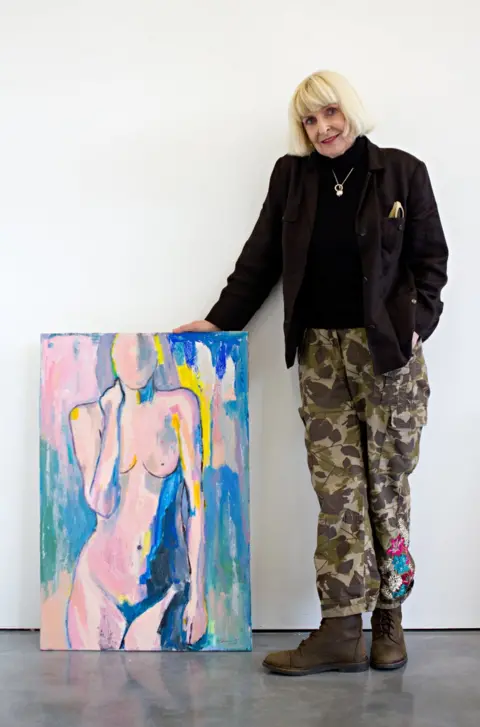 BBC Geraldine Crimmins standing next to her artwork