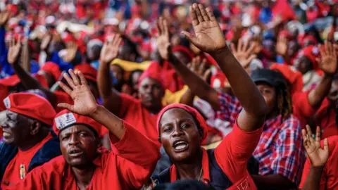 AFP Mourners and supporters of the Movement for Democratic Change (MDC) party wave good bye to Zimbabwe's iconic opposition leader Morgan Tsvangirai who died last week after a battle with cancer, on February 20, 2018, during his burial at his rural village Humanikwa in Buhera.