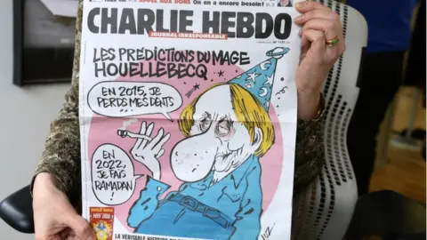 AFP The cover of Charlie Hebdo magazine on 7 January 2015, with a cartoon of Michel Houellebecq