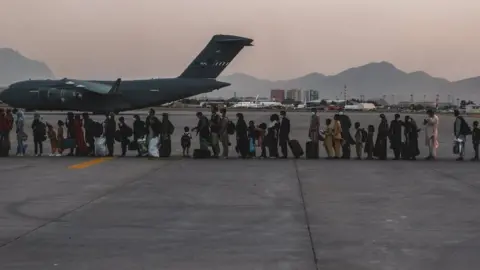 Reuters Evacuees wait to board a Boeing C-17 Globemaster