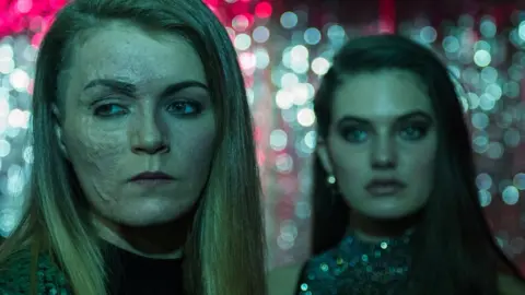 MODERN FILMS Vicky looking off camera with the actor who plays her friend in the film, on a night out