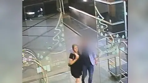 New Zealand Police Ms Millane and the man are seen entering his apartment building on their way to his room.