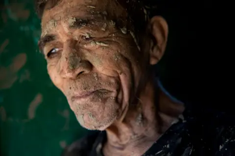 Eloisa Lopez / Reuters A man covered in mud in San Mateo, Rizal province, Philippines, 13 November 2020