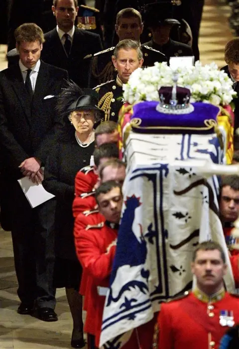 Getty Images Queen Elizabeth II (front, C) leads her family as she follows pall bearers carrying the coffin of Queen Elizabeth, the Queen Mother out of Westminster Abbey after the funeral service in London 09 April 2002.