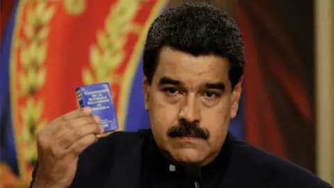 Reuters Venezuela's President Nicolas Maduro holds up a book of the country's constitution during a news conference at Miraflores Palace in Caracas, Venezuela August 22, 2017.