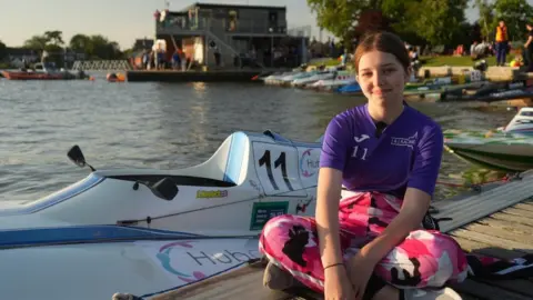 Jamie Niblock/BBC Abbie Haylock sitting on a boating dock