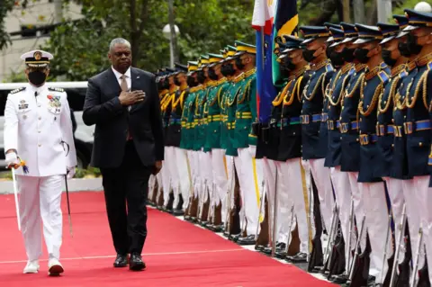 Getty Images United States Defense Secretary Lloyd Austin (R) walks past military guards during arrival honors at the Department of National Defense in Camp Aguinaldo military camp on February 2, 2023 in Quezon City, Manila, Philippines.