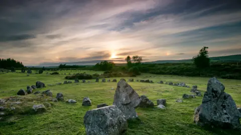 Ancient stone circles at Beaghmore in the Sperrin Mountains near Omagh, Northern Ireland, rising from a grassy landscape.
