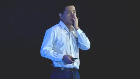 Getty Images Robin Li wiping water from his face