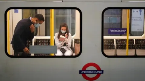 Reuters People wearing masks on Tube