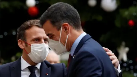 Reuters French President Emmanuel Macron welcomes Spanish Prime Minister Pedro Sanchez at the Elysee Palace as part of events marking the 60th anniversary of the signing of the OECD convention in Paris, France, on 14 December 2020.