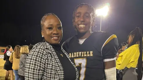LaTonya Allen Phil Dowdell and his mother at a football game