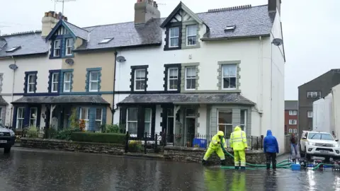 PA Media Flooded streets in Cockermouth