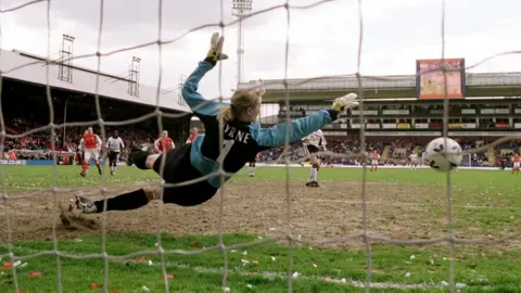 Mike Hewitt/Allsport Arsenal goalkeeper Emma Byrne saves Margunn Haugenes' penalty