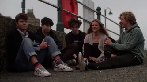 Group shot of Danny, Tamia and Jack with friends