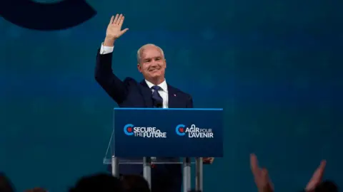 Getty Images Erin O'Toole waving to supporters at an event in September 2021