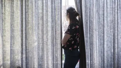 Getty Images stock photo - woman looking out window