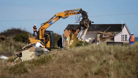 PA Media Demolition work takes place on a wooden home on The Marrams in Hemsby