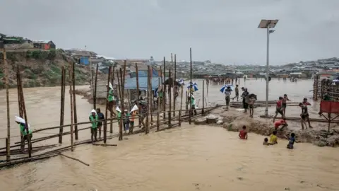 Unicef Bamboo bridge across flooded river