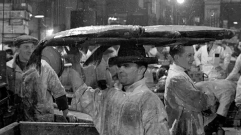 Getty Images man with halibut on his head