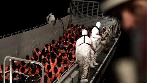 Reuters Migrants are rescued by staff members of the MV Aquarius, a search and rescue ship run in partnership between SOS Mediterranee and Medecins Sans Frontieres in the central Mediterranean Sea, June 10, 2018.